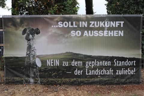 Auf großflächigen Bannern zeigen die Standort-Gegner auf, wie die Landschaft am Ortseingang von Bechtolsheim nach dem hier geplanten Bau des Mobilfunkmastes einmal aussehen könnte.               Foto: Rolf Lehmann