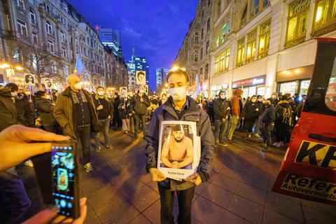 Der Vater des Opfers Ferhat Unvar hält ein Porträt seines Sohnes während einer Demonstration zum Gedenken an den Anschlag von Hanau. Der Veranstalter ist die "Initiative 19. Februar".  Foto: Andreas Arnold/dpa